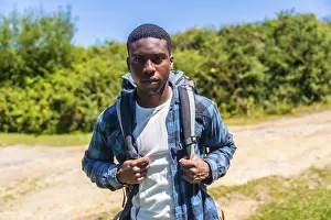 Confident young hiker wearing a backpack