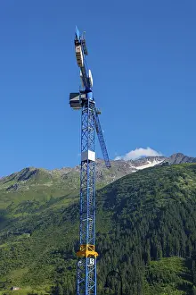 Construction Crane and swiss Alps with Blue Clear Sky and Sunlight in Andermatt