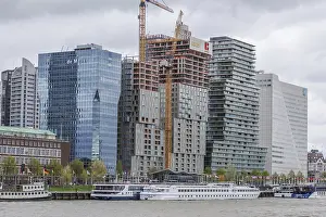 Construction site with modern high-rise buildings and cranes in an urban cityscape by the river