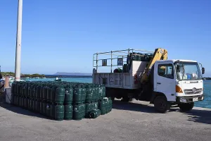 Container being unloaded, cargo consists of gas cylinders