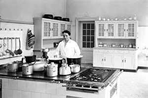 Cook in a large kitchen, ca. 1930s