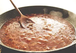 Cooking, bolognese sauce, in a frying pan