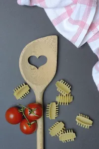 Cooking spoon with heart and Italian pasta