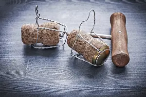 Two corcks with wires of champagne and corckscrew