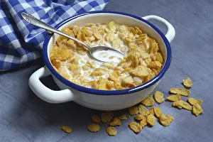 Cornflakes with milk in bowl, breakfast