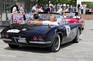Corvette C 1, black convertible on the road at a classic car event with several participants