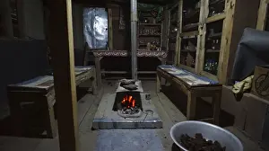 Cosy interior with illuminated wood stove at dusk or nighttime