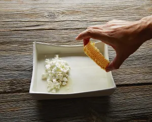 Cottage cheese curd with Honey honeycomb dessert chef hand preparation