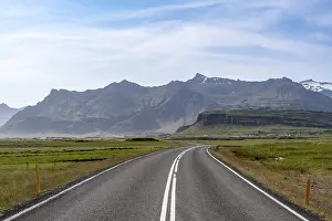 Country road, mountain landscape behind