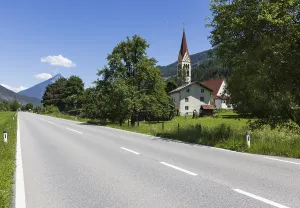 Country road, view of village with parish church
