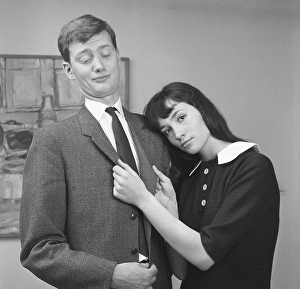 Couple in the 1950s. A young couple pictured at home where she is show affection for him but he is not interested