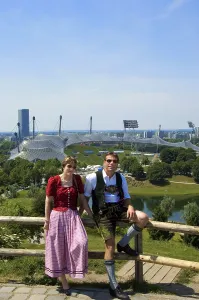 Couple in Bavarian traditional costume in front of Olympic Stadium