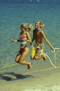 Couple on the beach, beach running and jumping rope