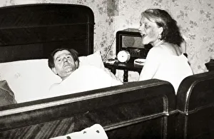 Couple in bedroom, man is lying in bed