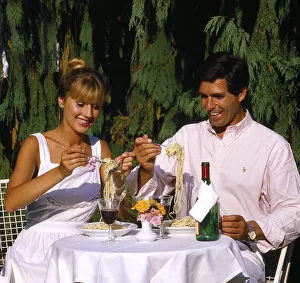 Couple eating spaghetti on terrace Photo