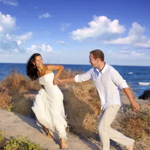 Couple in love running at the beach on Mediterranean