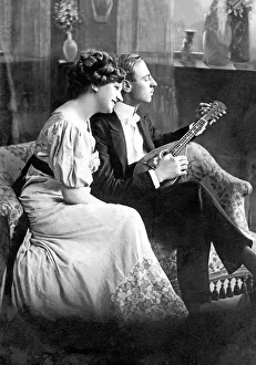 Couple, lovers, man playing the guitar for his lover