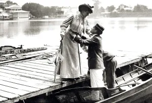 Couple, man helps woman into boat