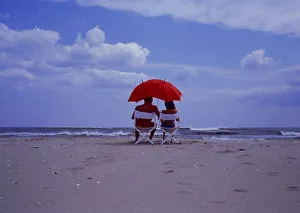 Couple with parasol on the beach