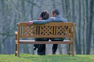 Couple sitting on park bench