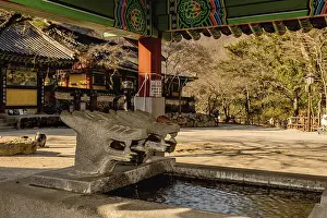 Covered water cistern with dragon head fountains at Buddhist temple