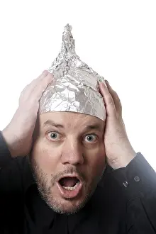 crazy scared man wearing tin foil hat