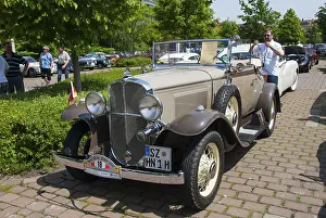 Cream-coloured convertible in a sunny ambience