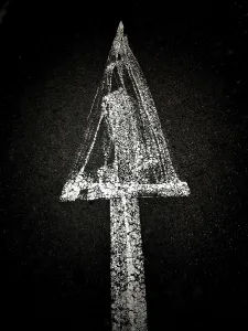 A creative chalk drawing on a dark background depicts a triangular shape with a textured surface surrounding a hidden