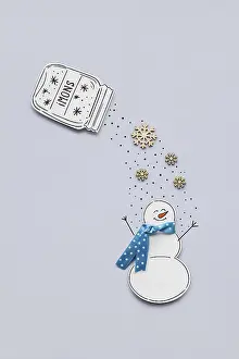 Creative photo of a paper snowman on a grey background