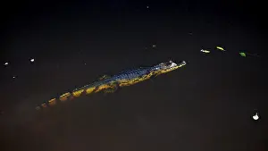 A crocodile swims calmly in the dark water