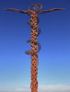 Cross entwined by a brass serpent