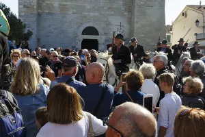 Crowd in front of the church, guardians of the Camargue