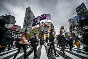 Crowd crossing zebra crossing on a large intersection