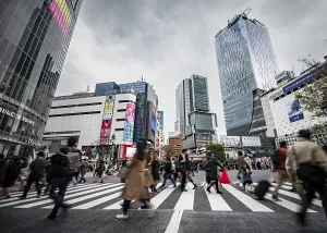Crowd crossing zebra crossing on a large intersection