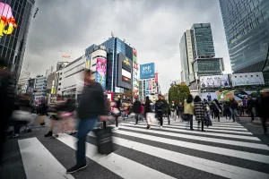 Crowd crossing zebra crossing on a large intersection