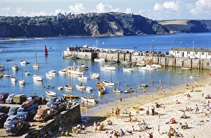 Crowded sandy beach at Tenby harbour, Pembrokeshire, Wales, United Kingdom in the late 1950s