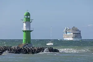 Cruise ship AIDA nova leaving, lighthouse