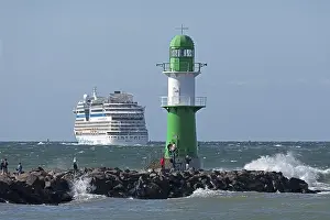 Cruise ship AIDA nova leaving, lighthouse