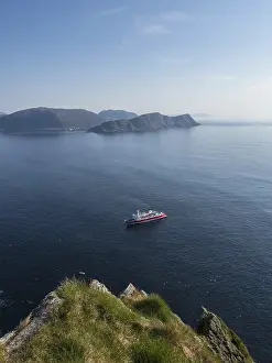 A cruise ship passes the island of Runde off the Norwegian coast