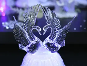 Crystal swans on a dark background