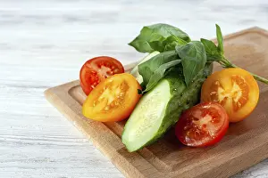Cucumber, yellow and red tomato and basil