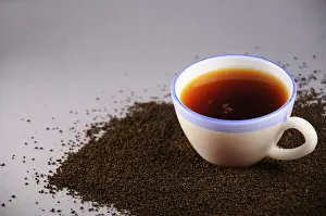 Cup of tea with and black tea leaves