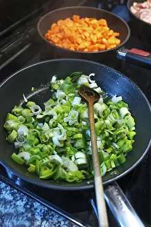 Cut vegetables, leeks and carrots in pans on the stove