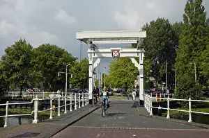 Cyclist on a bridge with the city coat of arms