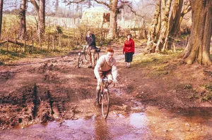 Cyclist on a country lane crossing a stream, South England, Great Britain 1957