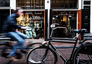 Cyclist rides through shopping street