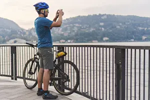 Cyclist taking pictures with smart phone