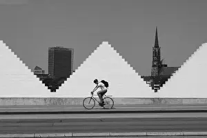Cyclist in front of white wall