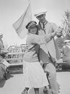 Dancing in he 1920s. A young couple dancing outside holding each other