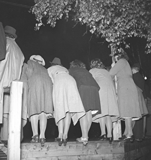 Dancing in the 1940s. A group of young women are standing against the side at a dance event